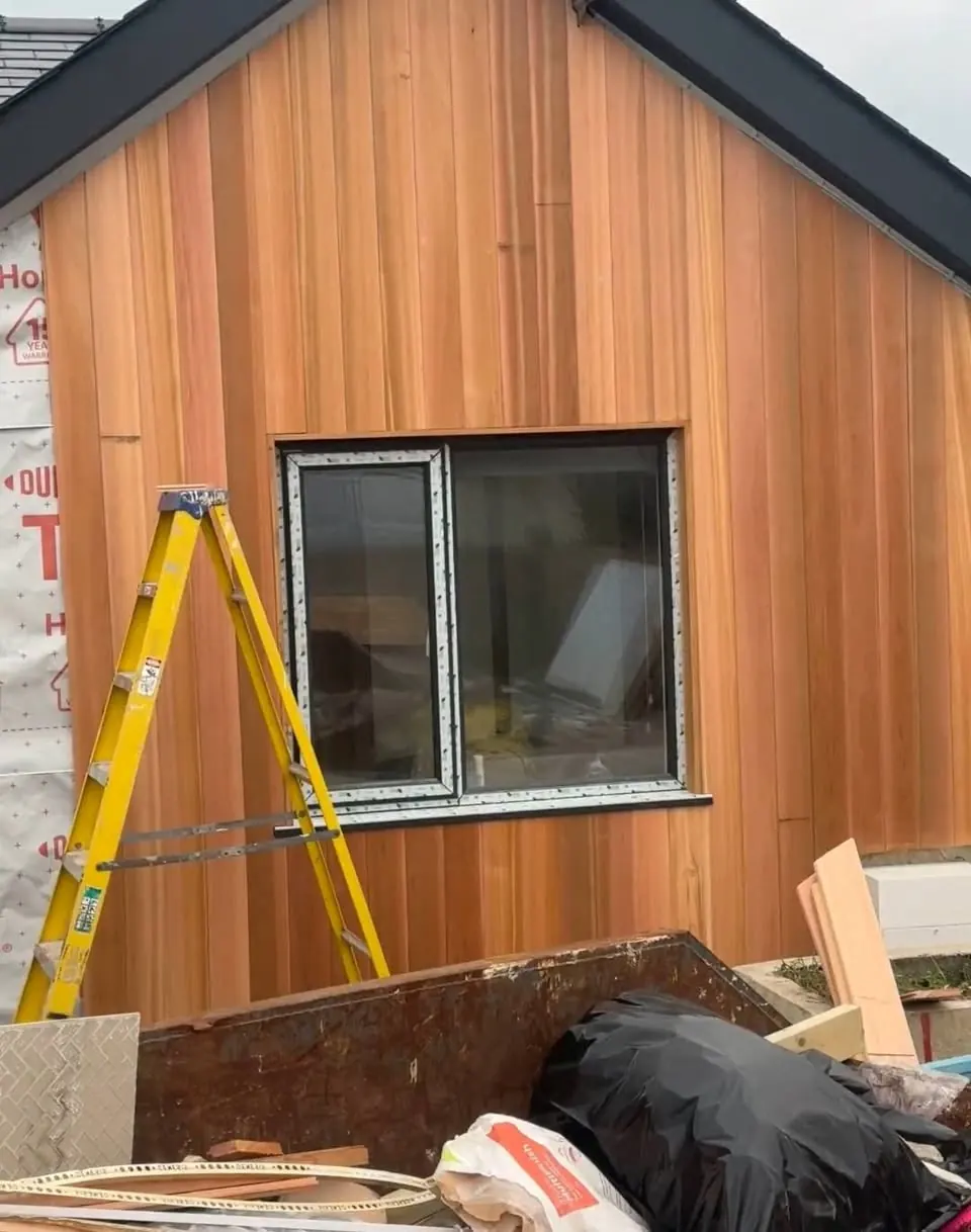 Western red cedar cladding going on around a new window, a real Crews Carpentry job
